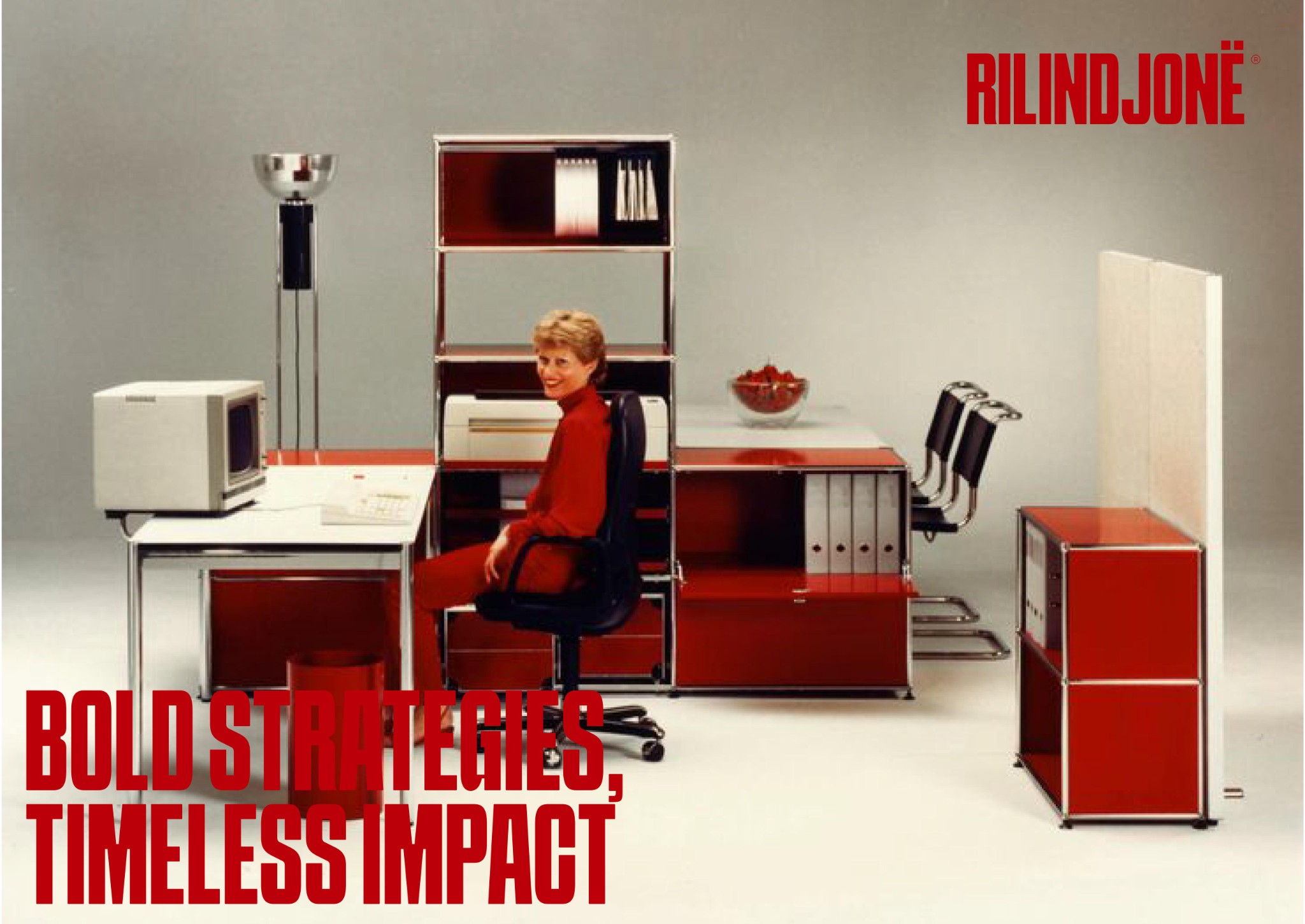 Red office — RILINDJONË woman at modular red desk, Bold Strategies Timeless Impact